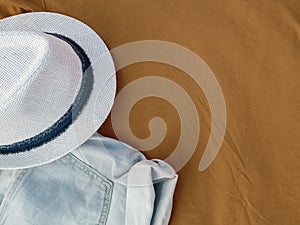 Flat lay fashion women summer beachwear accessories: shorts and hat on a beige vacation background. Top view. Copy space