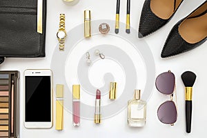 Flat lay feminine accessories collage with beige high heel shoes, sunglasses and cosmetics set on white background. Text space. Be