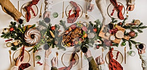 Flat-lay of Festive Christmas table setting and celebrating people