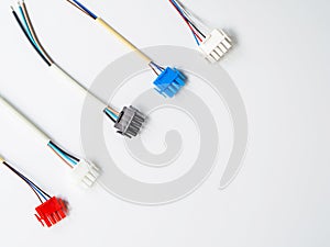 Flat lay few colorful wire connectors and wires on a white background with copy space