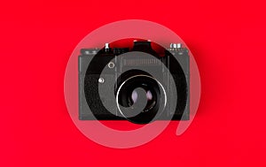 Flat lay film camera isolated on red background. Copy space