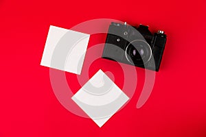 Flat lay film camera isolated on red background. Copy space