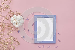 Flat lay flowers, photo frame on pink background