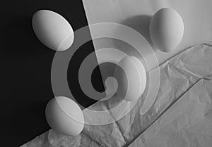 flat lay of four eggs in classical 1920\'s style, black and white shot with free copy space