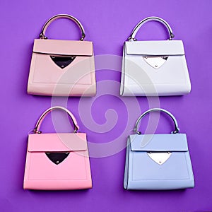 Flat lay of four trendy leather women\'s top-handle bags of the same design but different colors on a purple background.