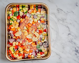 Flat lay of fresh Mediterranean vegetables in a silver baking tray