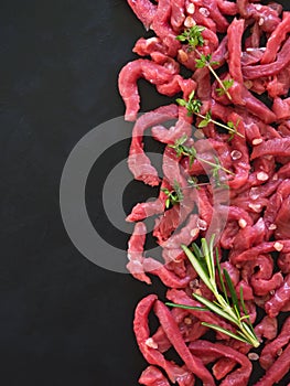 Flat-lay of fresh raw beef meat on black table