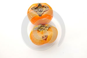 Flat lay fresh sweet ripe orange persimmon cut in half fruit isolate on a white background