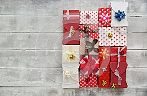 Flat Lay with Gift boxes, Ribbons, Decorations in red colors.