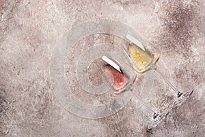 Flat lay glass with rose and white wine. Top view. Degustation concept photo