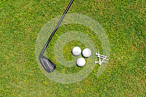 Flat lay with golf club, balls nad tees on green grass of golf course