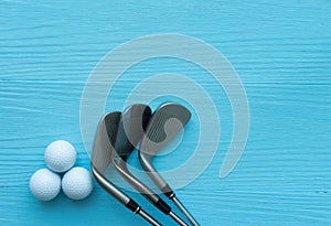 Flat lay : Golf clubs, golf balls on blue wooden table