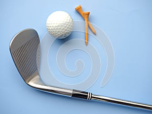 Flat lay of golf equipments on blue background - sport and hobby concept