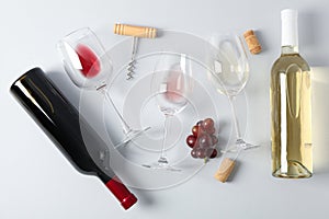 Flat lay. Grapes, corkscrew, bottles and glasses with wine