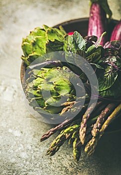 Flat-lay of green and purple vegetables on plate, selective focus