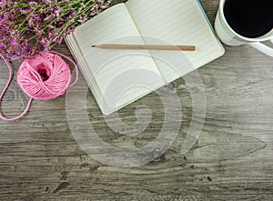 Flat lay grey wooden desk with stationery,flowers and coffee