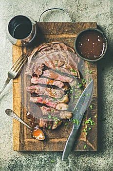 Flat-lay of grilled medium rare ribeye beef steak