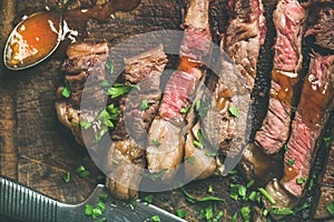 Flat-lay of grilled ribeye beef steak cut into peices
