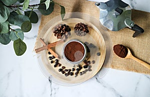 Flat lay ground coffee in the MOKA pot on the marble table