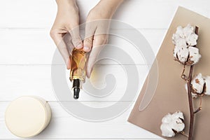 flat lay hands holding body care product wooden background. High quality photo