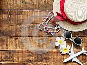 Flat lay of hat , necklace , sun glass , flower and red heart shape as traveler`s accessories items for summer vacation and plane