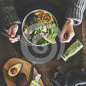 Flat-lay of healthy superbowl, smoothie and womans hands, square crop