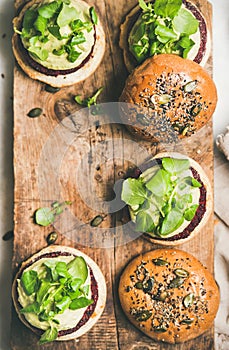 Flat-lay of healthy vegan burgers with beetroot patties, copy space
