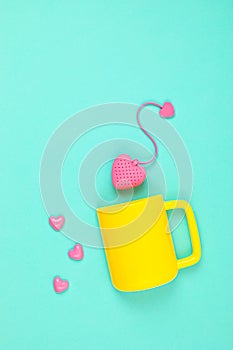 Flat lay with heart shaped tea bag and cup. Waking up, morning tea, every day rituals, zen attitude, destress, healthy drink, love