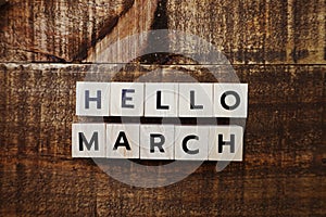 Flat lay Hello March alphabet letters on wooden background