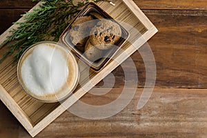 Flat lay hot cappuccino and chocolate chip cookies on old wood