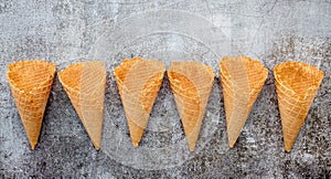 Flat lay ice cream cones collection on dark stone background . Blank crispy ice cream cone with copy space for sweets menu design