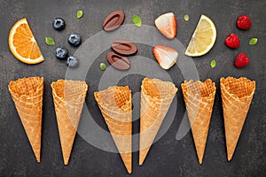 Flat lay ice cream cones collection on dark stone background . Blank crispy ice cream cone with copy space for sweets menu design
