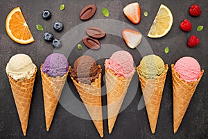 Flat lay ice cream cones collection on dark stone background . Blank crispy ice cream cone with copy space for sweets menu design