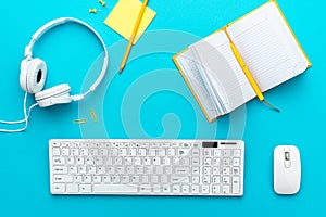 Flat lay image of home office table over turquoise blue background