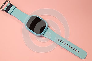 flat lay image of kids smart watch on pastel pink background