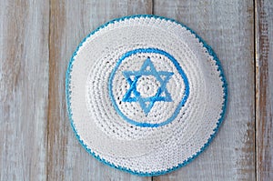Flat lay of a Knitted kippah with embroidered blue and white Sta