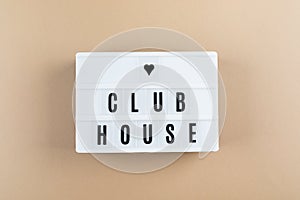 Flat lay of lightbox with text Clubhouse. Social application on the smartphone. New trend