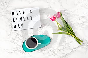 Flat lay with lightbox with text Have a lovely day and coffee cup. Social media, motivation quote, feminine blog, morning of photo