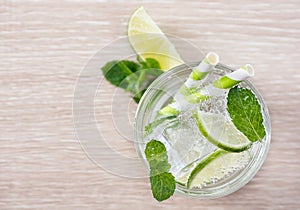 Flat lay lime mint soda on wood. Detox water. Mojito