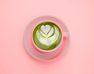 flat lay matcha green tea cup on a pastel pink background