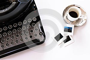 Flat lay of mechanical typewriter with espresso and film slides