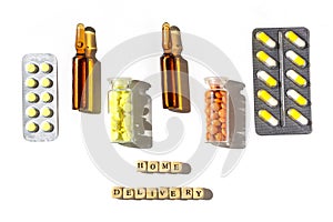 Flat lay of medical bottles, blisters with pills and capsules with home delivery text.