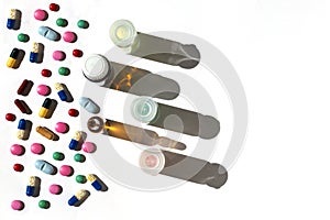Flat lay of medical bottles and pills and capsules with shadows and copy space.