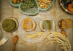 Flat lay mid autumn festival colorful food and drink on burlap background