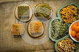 Flat lay mid autumn festival colorful food and drink on burlap background