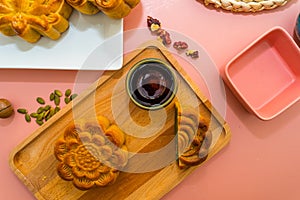 Flat lay mid autumn festival colorful food and drink on sweet pink background