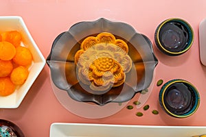 Flat lay mid autumn festival colorful food and drink on sweet pink background