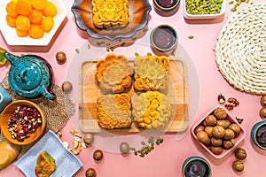 Flat lay mid autumn festival colorful food and drink on sweet pink background