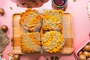 Flat lay mid autumn festival colorful food and drink on sweet pink background