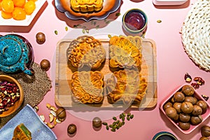 Flat lay mid autumn festival colorful food and drink on sweet pink background